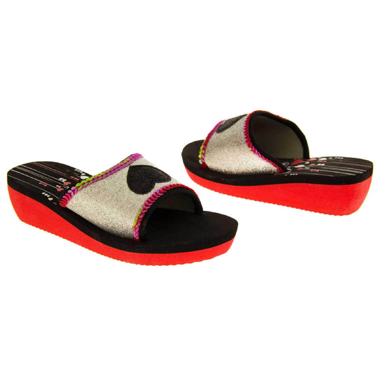 Foam wedge sandals for girls. Red bottom half of the sole with ridges for grip, black top half with red and white heart and line design to the heel of the insole. Silver glitter full strap with black glitter heart in the middle and pink sequins along the edges. Both feet from slight angle facing top to tail.