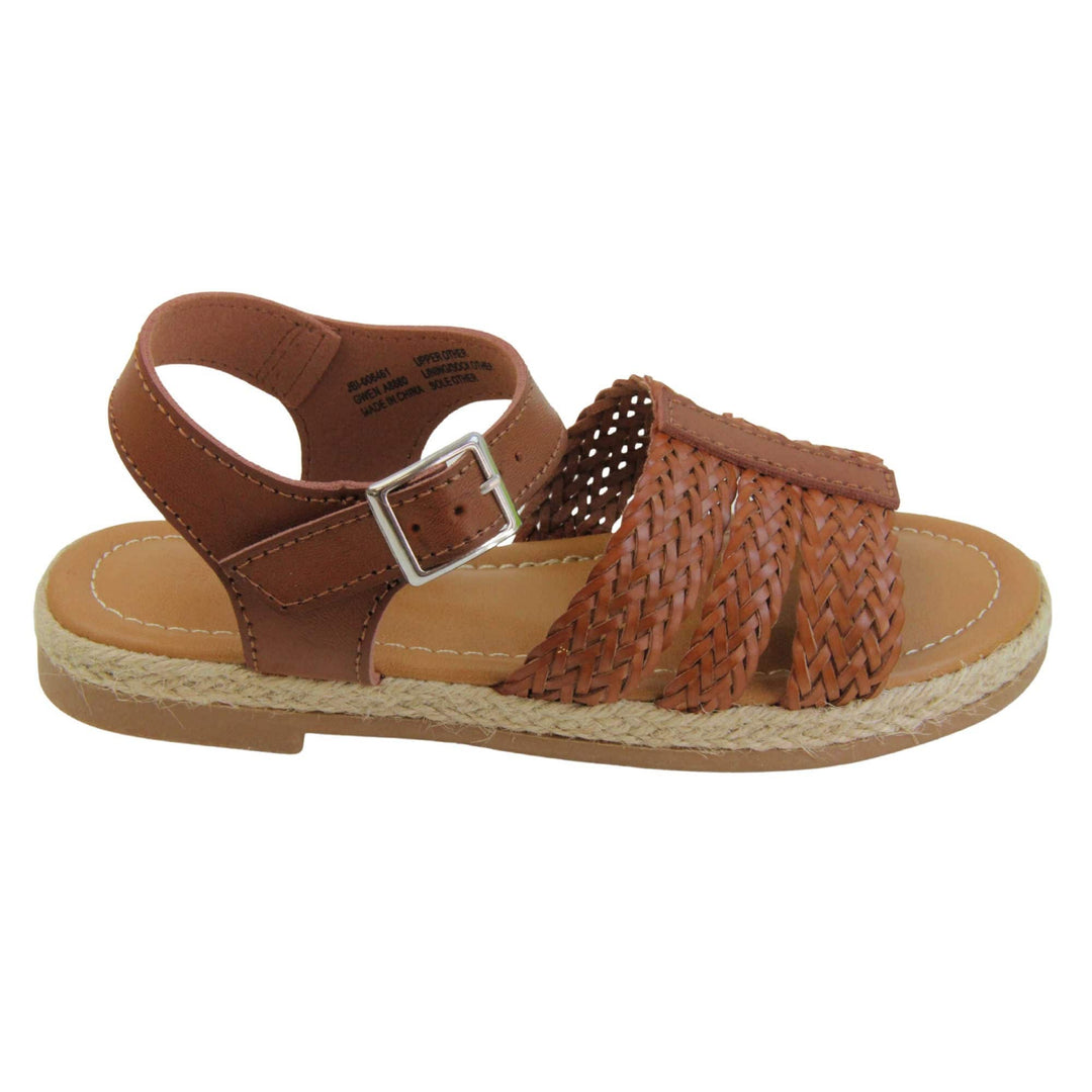 Girls flat sandals. Triple strap sandals with a faux leather dark brown upper. Three woven faux leather straps over the foot with a plain band down the middle. A plain ankle strap with silver buckle. Brown insole with brown lining. Brown outsole with jute rope style rim around the outside. Right foot from a side profile.