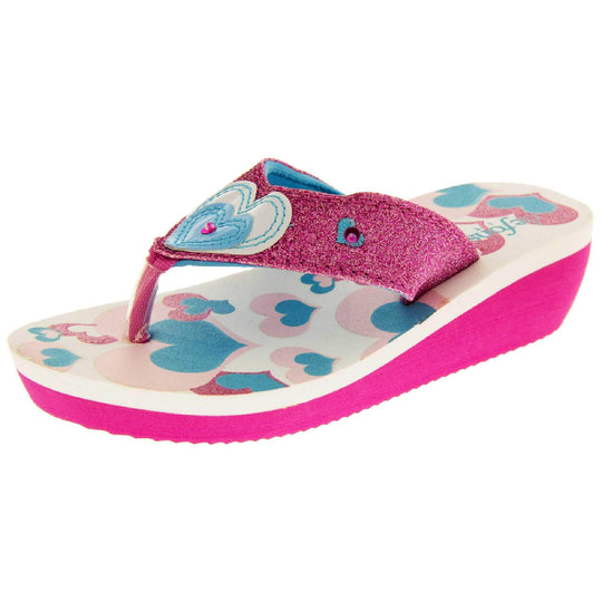 Girls glitter sandals. Foam wedge sandals for girls. Pink bottom half of the sole with ridges for grip, white top half with heart designs in pale pink, bright pink and teal. Bright pink glitter strap with toe-post. With cream and teal heart detail  to the strap and pink diamantes. Left foot at an angle.