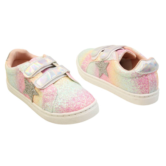 Girls glitter trainers. Kids trainers with a ombre rainbow upper done in glitter. With two silver holographic touch fasten straps. A silver glitter heart detail to the outside of the shoe in the middle of the foot. Pale pink textile lining and chunky white sole. Both feet at an angle facing top to tail.