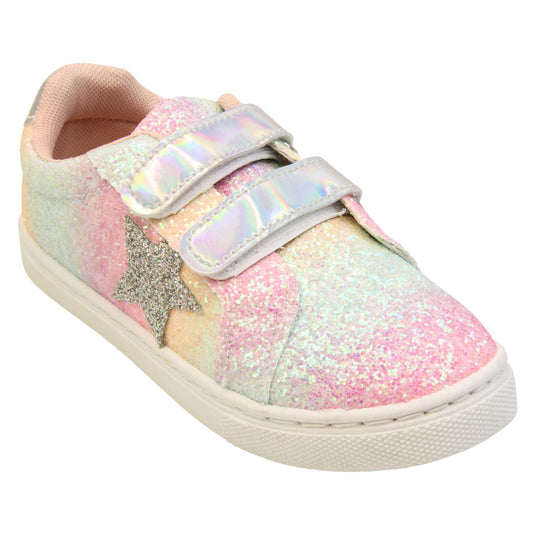 Girls glitter trainers. Kids trainers with a ombre rainbow upper done in glitter. With two silver holographic touch fasten straps. A silver glitter heart detail to the outside of the shoe in the middle of the foot. Pale pink textile lining and chunky white sole. Right foot at an angle.