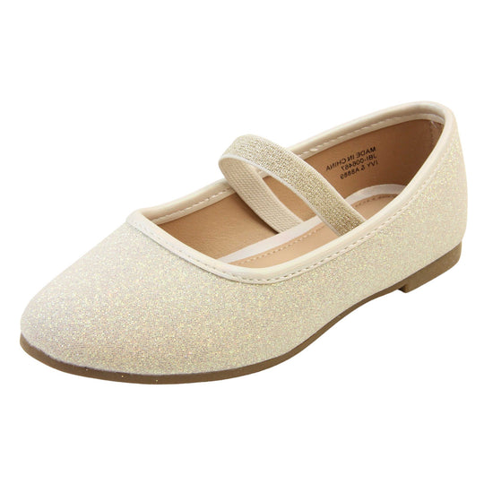 Girls party shoes. Ballerina style shoes with ivory glitter uppers. With a gold glitter elasticated over the foot strap. Cream faux leather collar and beige lining. Dark brown sole with very slight heel. Left foot at an angle.