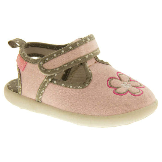 Girls sandals. Pink canvas t-bar pumps with white sole, flower detail to the front and brown edging with white dots.  Right foot at an angle