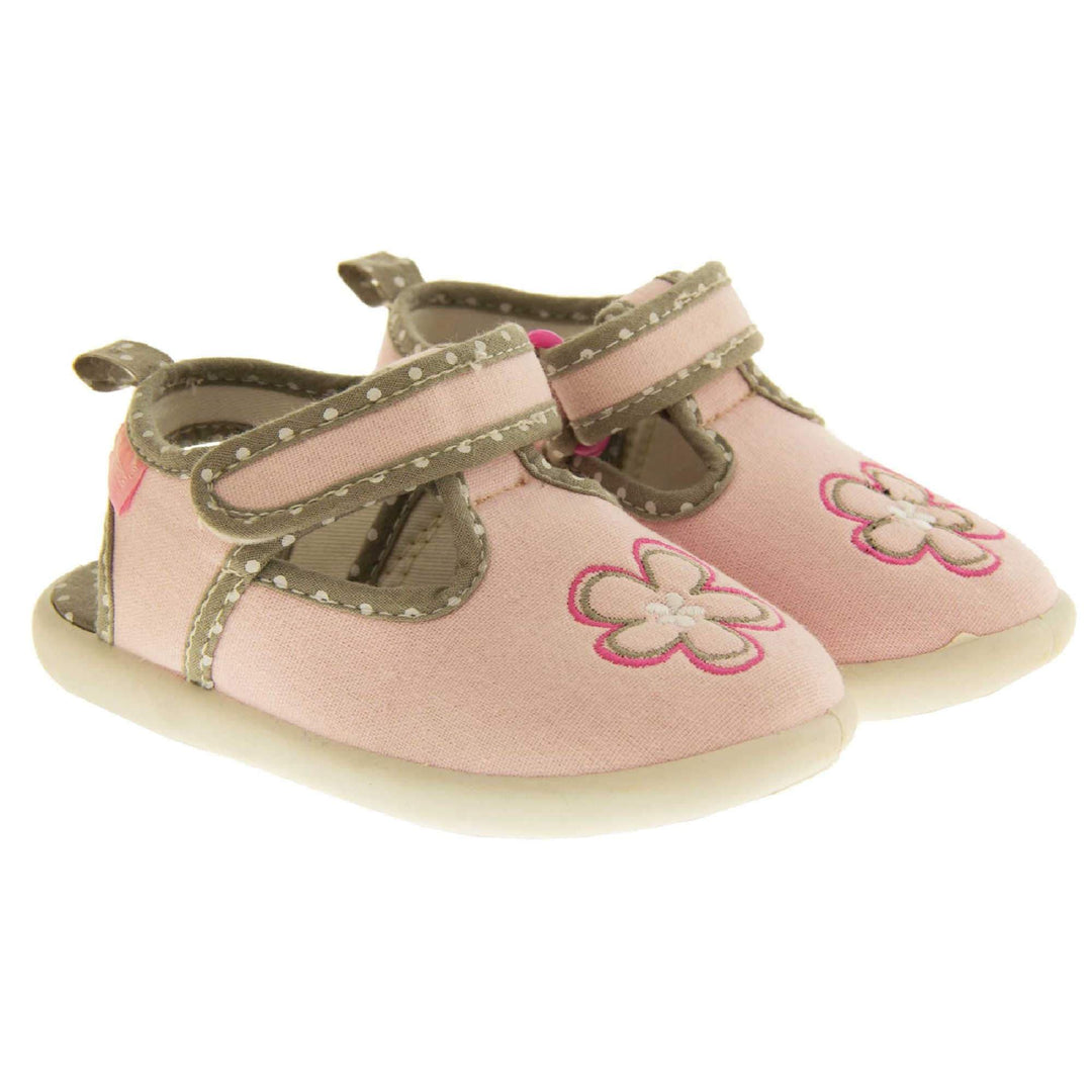 Girls sandals. Pink canvas t-bar pumps with white sole, flower detail to the front and brown edging with white dots. Both feet together