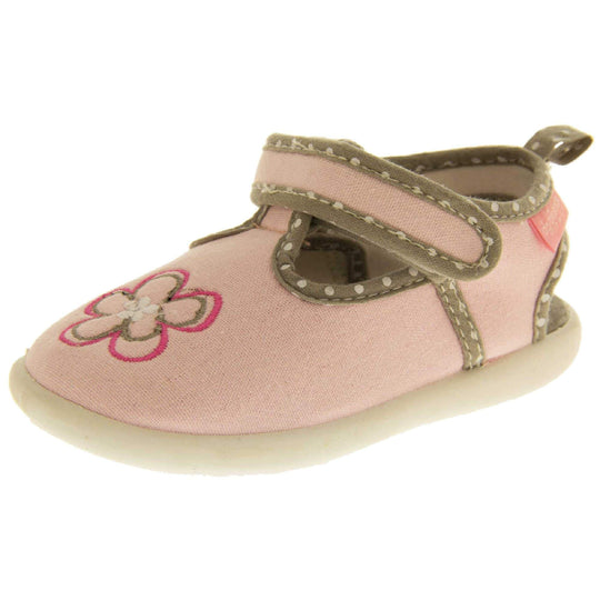 Girls sandals. Pink canvas t-bar pumps with white sole, flower detail to the front and brown edging with white dots. Left foot at angle