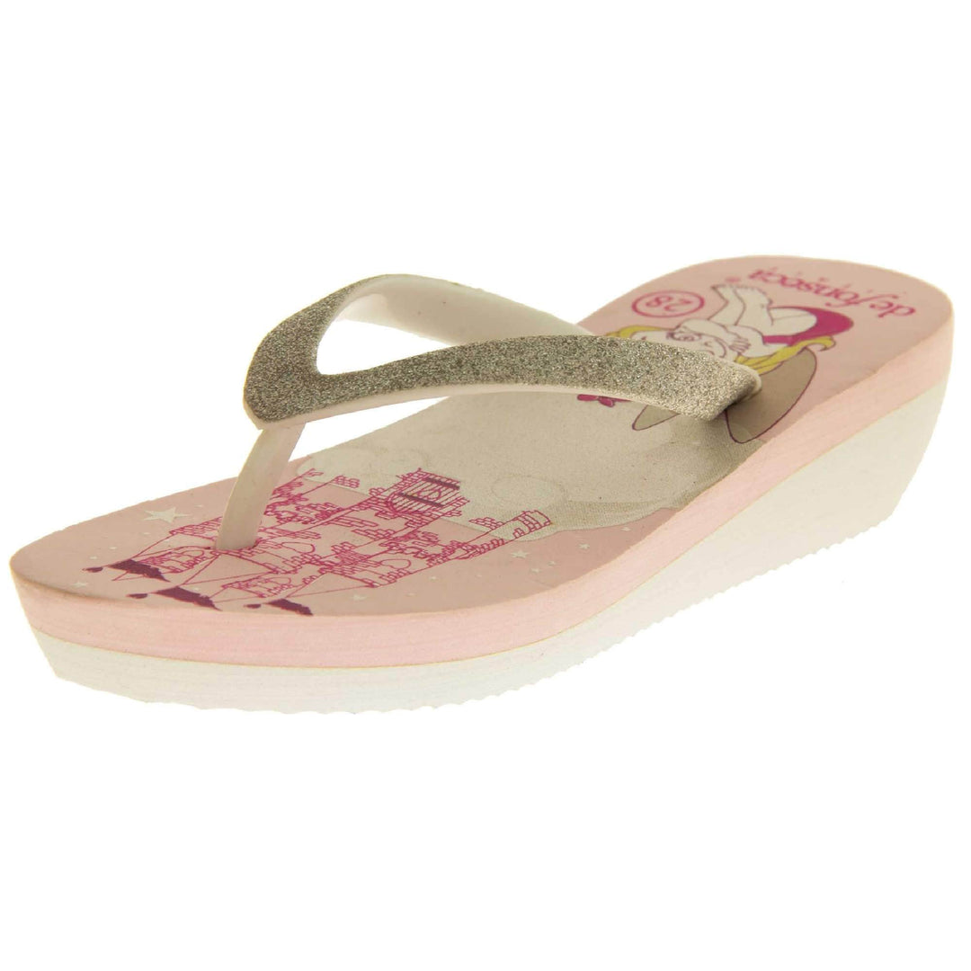 Foam wedge sandals for girls. White bottom half of the sole with ridges for grip, baby pink top half with bright pink fantasy design to the insole. White strap with toe post covered on top with pale gold glitter. Left foot at an angle.