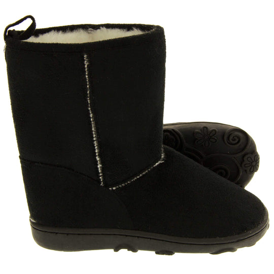 Girls winter boots - Black faux suede boots with visible stich detailing, Black sole with raised slip resistant grip and cream faux fur lining. Both feet with left foot on side so sole is visible.
