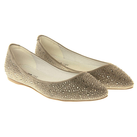 Gold flat pumps. Ballet style shoes with a taupe faux suede upper covered in gold diamantes. Cream leather lining and beige sole. Both feet together at a slight angle.