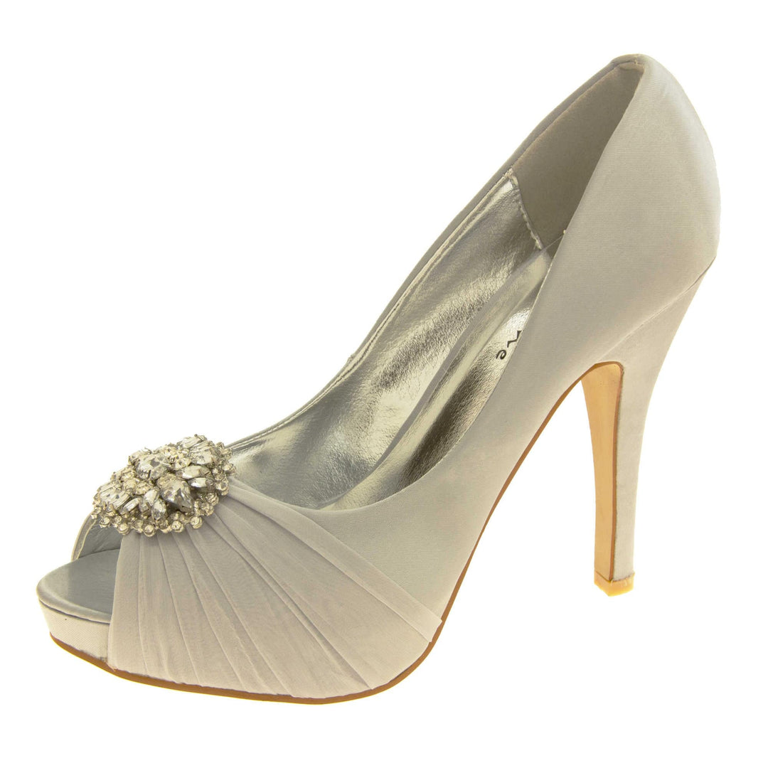 Grey satin heels. Classic women's peep toe high heels with a pale grey satin upper. Metallic silver insole with Sabatine branding. Grey satin stiletto heel with a cream sole. Diamante cluster and ruched detailing across the toes. Left foot at an angle.