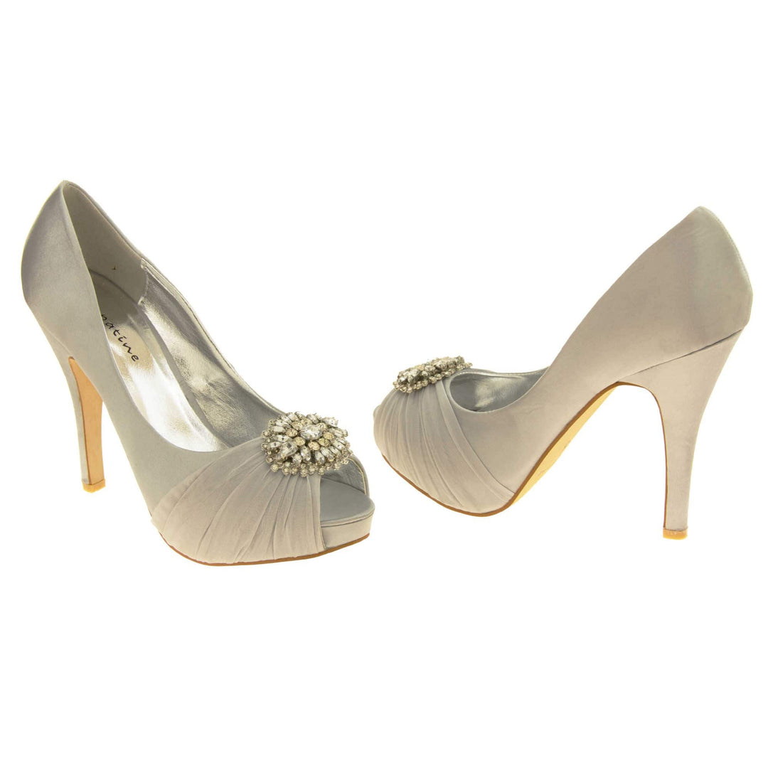 Grey satin heels. Classic women's peep toe high heels with a pale grey satin upper. Metallic silver insole with Sabatine branding. Grey satin stiletto heel with a cream sole. Diamante cluster and ruched detailing across the toes. Both feet at an angle facing top to tail.
