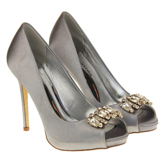 Grey satin shoes. Classic women's peep toe high heels with a grey satin upper. Metallic silver insole with Sabatine branding. Grey satin stiletto heel with a cream sole. Diamante cluster detailing across the toes. Both feet together at a slight angle.