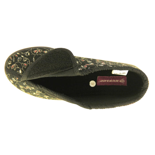 Hard sole slippers womens. Ladies bootie style slipper with a black textile upper with vine flower embroidered design. Touch fasten tab to the top and black textile lining. Firm black sole. Left foot from a birds eye view with the touch fasten tab open.