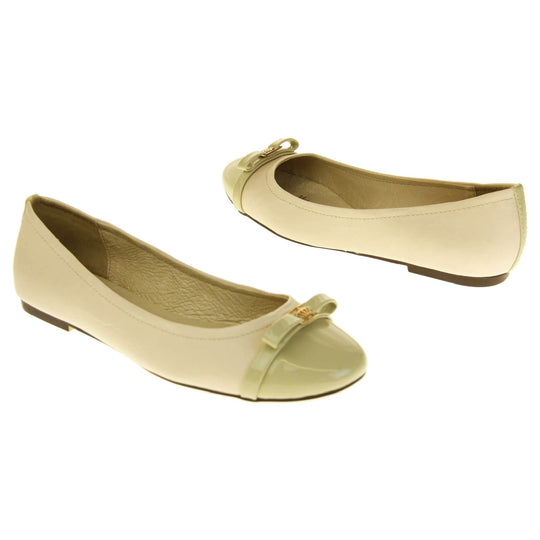 Cream ballet flats. Cream leather ballet pumps with pale green patent toe and bow detail. Pale green patent stripe down the heel of the upper. Beige outsole with black rim and with a very slight heel.  Both feet at an angle facing top to tail.