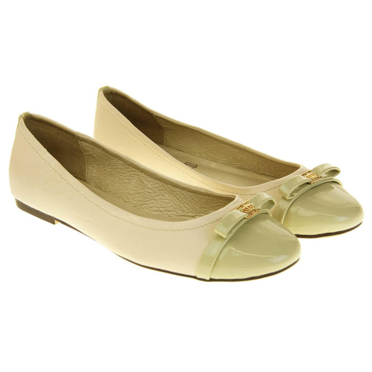 Cream ballet flats. Cream leather ballet pumps with pale green patent toe and bow detail. Pale green patent stripe down the heel of the upper. Beige outsole with black rim and with a very slight heel. 