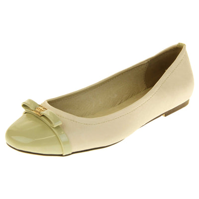 Cream ballet flats. Cream leather ballet pumps with pale green patent toe and bow detail. Pale green patent stripe down the heel of the upper. Beige outsole with black rim and with a very slight heel. Left foot at an angle.