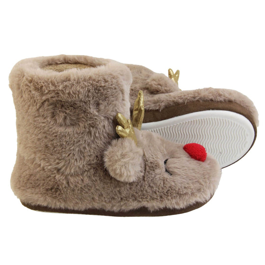 Kids animal slippers. Furry slipper boots in a brown faux fur with a cute reindeer face on. With a red pom pom nose and gold shiny antlers. The same colour fleece lines the boot. Both feet from a side profile with left foot on its side to show the sole.