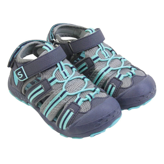 Kids beach sandals. Strappy beach sandals with grey mesh and navy faux leather uppers. with turquoise and navy textile strap detailing. Turquoise elasticated faux laces to the front. Navy faux leather straps around the front and back of the ankle with touch fastening. Turquoise insole. Navy rubbery outsole and toe bumper with turquoise and navy grip on the bottom. Both feet together at an angle.