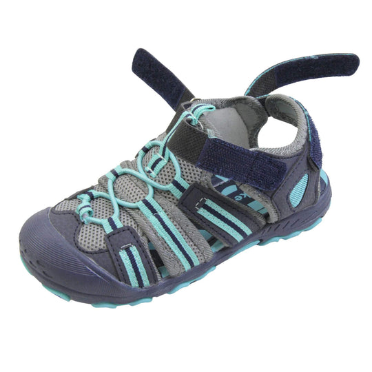 Kids beach sandals. Strappy beach sandals with grey mesh and navy faux leather uppers. with turquoise and navy textile strap detailing. Turquoise elasticated faux laces to the front. Navy faux leather straps around the front and back of the ankle with touch fastening. Turquoise insole. Navy rubbery outsole and toe bumper with turquoise and navy grip on the bottom. Left foot at an angle with the front and back straps open to show the adjustablility.