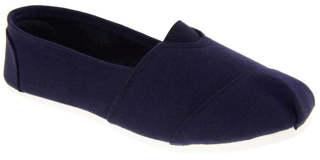 Kids canvas shoes. Navy blue canvas upper with elasticated panel in the middle where the tongue would be. White synthetic sole. Navy textile lining and insole. Right foot at an angle