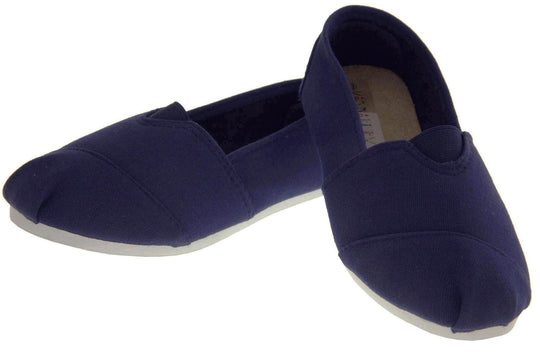 Kids canvas shoes. Navy blue canvas upper with elasticated panel in the middle where the tongue would be. White synthetic sole. Navy textile lining and insole. Both shoes in a V shape with the heel of the left foot resting on top of the right foot heel.