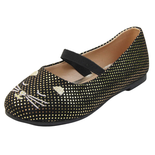 Kids cat shoes. Ballerina style shoes with black faux suede uppers with metallic gold dotty print and embroidered cat face to the front. With a black elasticated over the foot strap. Beige lining and dark brown sole with very slight heel. Left foot at an angle.