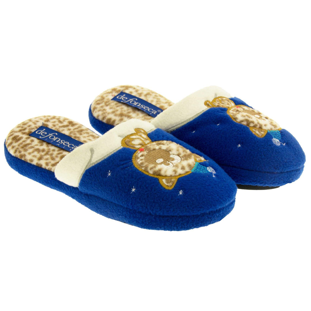Kids cat slipper. Mule slipper with royal blue upper. Cream trim to the top of the upper, along the bridge of the foot. With an embroidered leopard print cat sat on the trim with a little blue night cap on and stars around him. The insole of the slipper is leopard print with a blue De Fonesca label on it. With a black sole. Both feet from an angle next to each other.