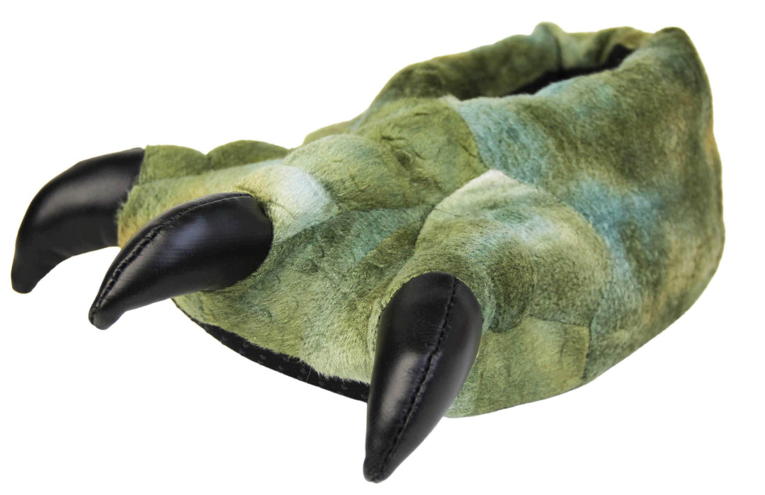 Kids dinosaur slippers. Cushioned slippers shaped like a dinosaur foot. Green textile outer with scale type pattern and black shiny padded claws. Inside is a textile lining. Black soft sole with bumps on for grip. Left foot at an angle.