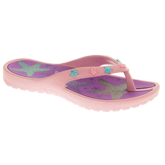 Kids flip flops girls. Pale pink flip flops with toe post strap. Purple insole with glittery heart design on. Small pink and teal plastic stars along the strap. Slip-resistant grip to the sole. Left foot view