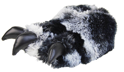 Kids fluffy slippers. Cushioned slippers shaped like a monster's foot with claws . Black and grey faux fur outer and black shiny padded claws. Inside is a textile lining. Black soft sole with bumps on for grip. Left foot at an angle.