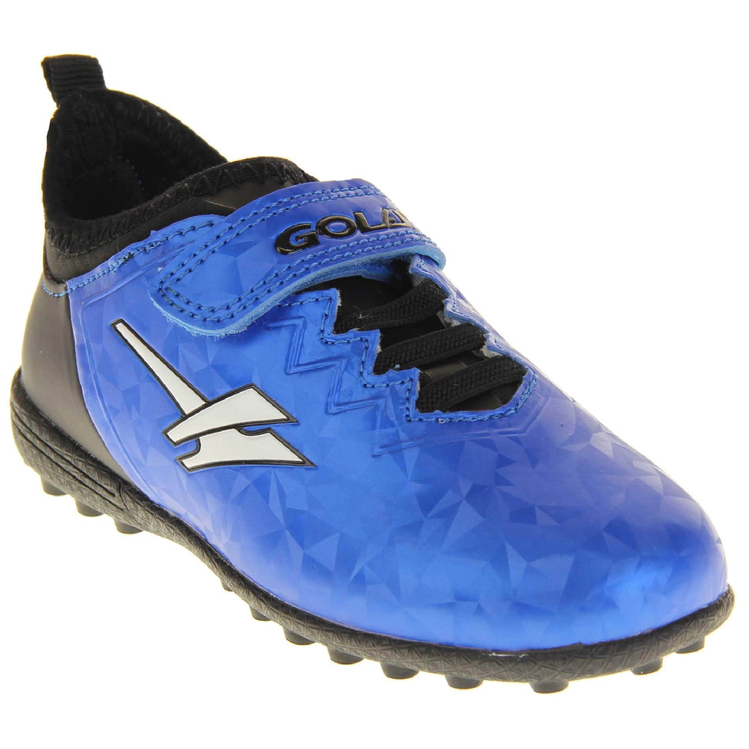 Kids football trainers. Metallic cerulean blue Gola boots with white Gola logo to the sides. With black heel and tongue and black elastic lace detail to the front. Metallic blue touch close strap with Gola branding across it. Black soles with small Astroturf studs. Right foot at an angle