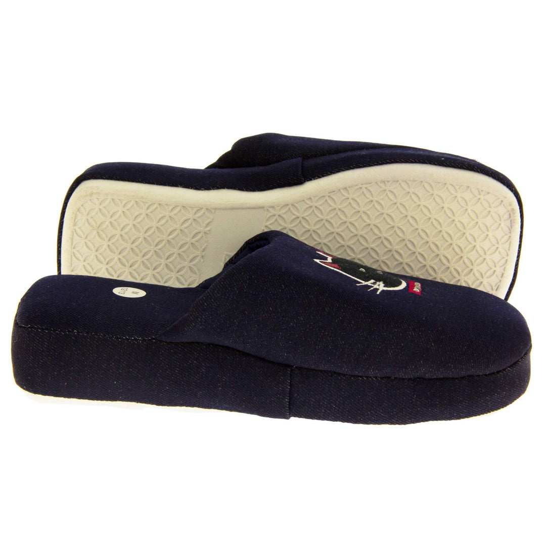 Kids mule slippers. Mule slippers made from a dark blue denim. Padded sole in the same denim with a firm white synthetic outsole. Stitched cat face in white and pink thread on the upper. Both feet from a side profile with the left foot on its side to show the sole.