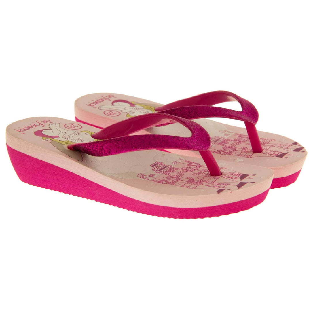 Foam wedge sandals for girls. Fuchsia bottom half of the sole with ridges for grip, baby pink top half with bright pink fantasy design to the insole. Fuchsia strap with toe post covered on top with bright pink glitter. Both feet next to each other at an angle.