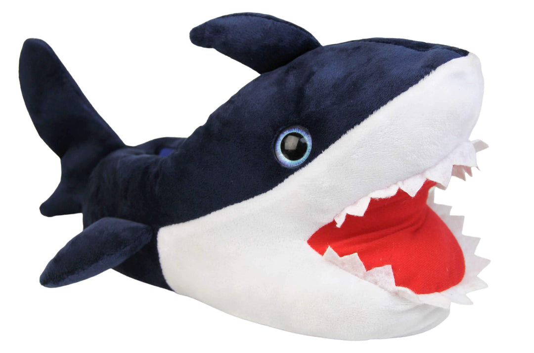 Kids shark slippers. Padded slippers in the shape of a shark with its mouth open. Blue upper and tail and white mouth and belly. Mouth is red felt with white felt shark teeth around the edge. Blue false eyes. Right foot at an angle.