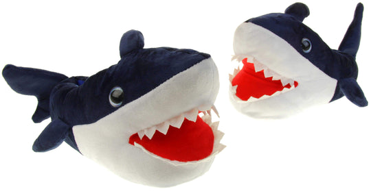 Kids shark slippers. Padded slippers in the shape of a shark with its mouth open. Blue upper and tail and white mouth and belly. Mouth is red felt with white felt shark teeth around the edge. Blue false eyes. Both feet in a v shape, left foot slightly behind.
