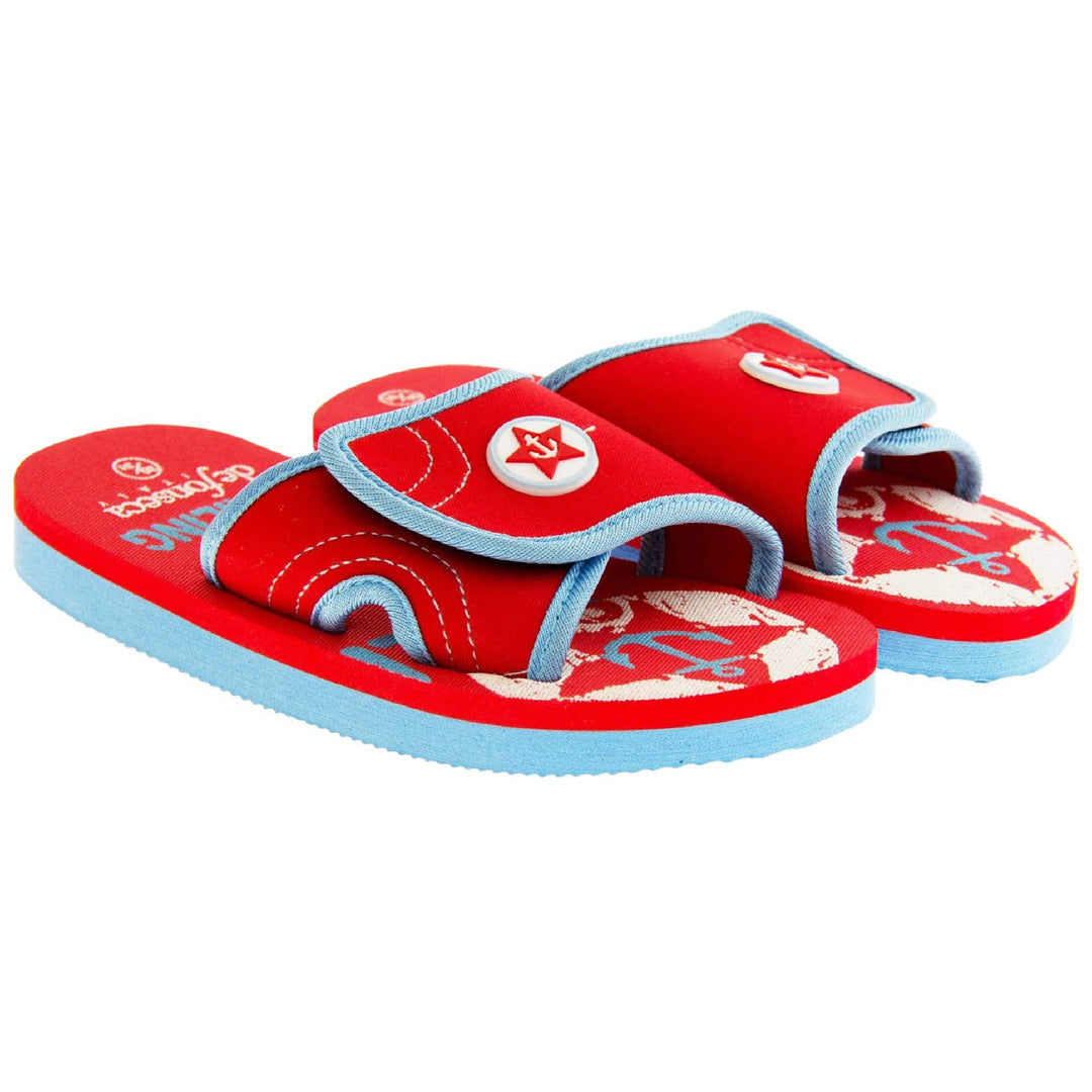 Kids slip on sandals. Slip on slider style sandals. Red touch fasten strap with light blue around the edge and a white synthetic circle in the centre of the strap with red anchor in the middle. The foam sole is two toned. The top half is red, the bottom half is pale blue. Both shoes next to each other at a slight angle. 
