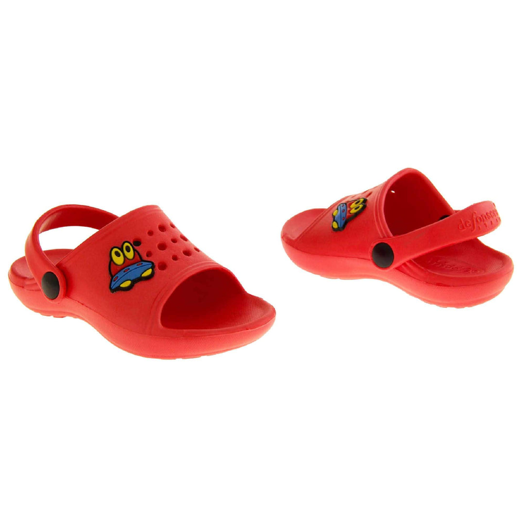 Kids Summer Clogs. Red synthetic clog style shoes. Open toed with cut out holes in the upper with alien detail just off centre. Red strap that goes along the back of your heel. The strap can be moved along the top of the shoe instead to make the shoe a mule. Both shoes at an angle facing top to tail.