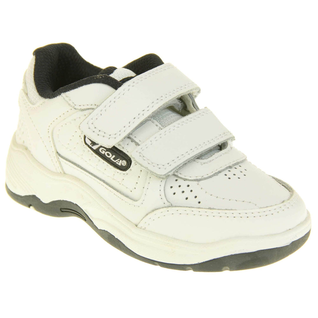 Kids trainers. White leather Gola trainers with fabric tongue. With Gola branding and logo on the side and two touch close straps. The lining is black textile. White chunky sole with black base. Right foot at an angle.