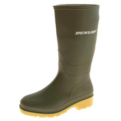 Kids Wellies. Green knee high wellies with a waterproof rubber upper and sole. With white Dunlop logo and brand on the side. Beige coloured rubber sole. Left foot at an angle.
