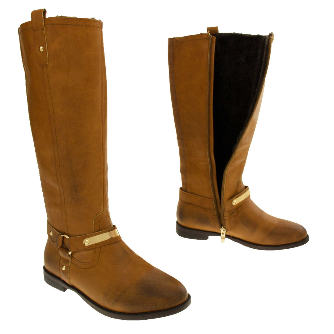 Knee high boots leather tan. Knee high style boots with a tan colour faux leather upper. Tri strap going around the ankle and down to the bottom of the boot joined by the ankle with a good loop. Gold plate to the front of the ankle strap. Zip up the inside of the boot. Faux leather loop on the top of the outside of the boot to help with pulling it on. Both feet about a foot apart from the side. Left foot showing the inside of the boot unzipped and the faux fur lining.