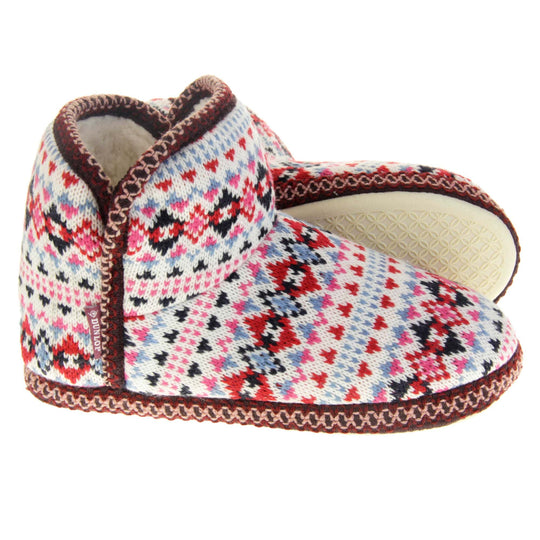 Knitted boot slippers. Womens ankle boot style slippers with a white knit upper and multi coloured pattern in a Scandinavian Aztec style. Cream plush faux fur lining. Both feet from a side profile with the left foot on its side behind the the right foot to show the sole.