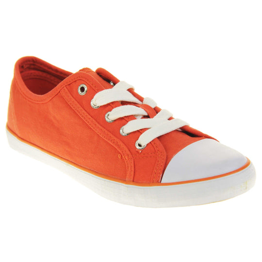 Lace up canvas sneakers. Women's shoes in a low top sneaker style with a orange canvas upper. White laces and white rubber toe bumper. Orange textile lining and white outsole with an orange line running around it and beige base. Right foot at an angle.