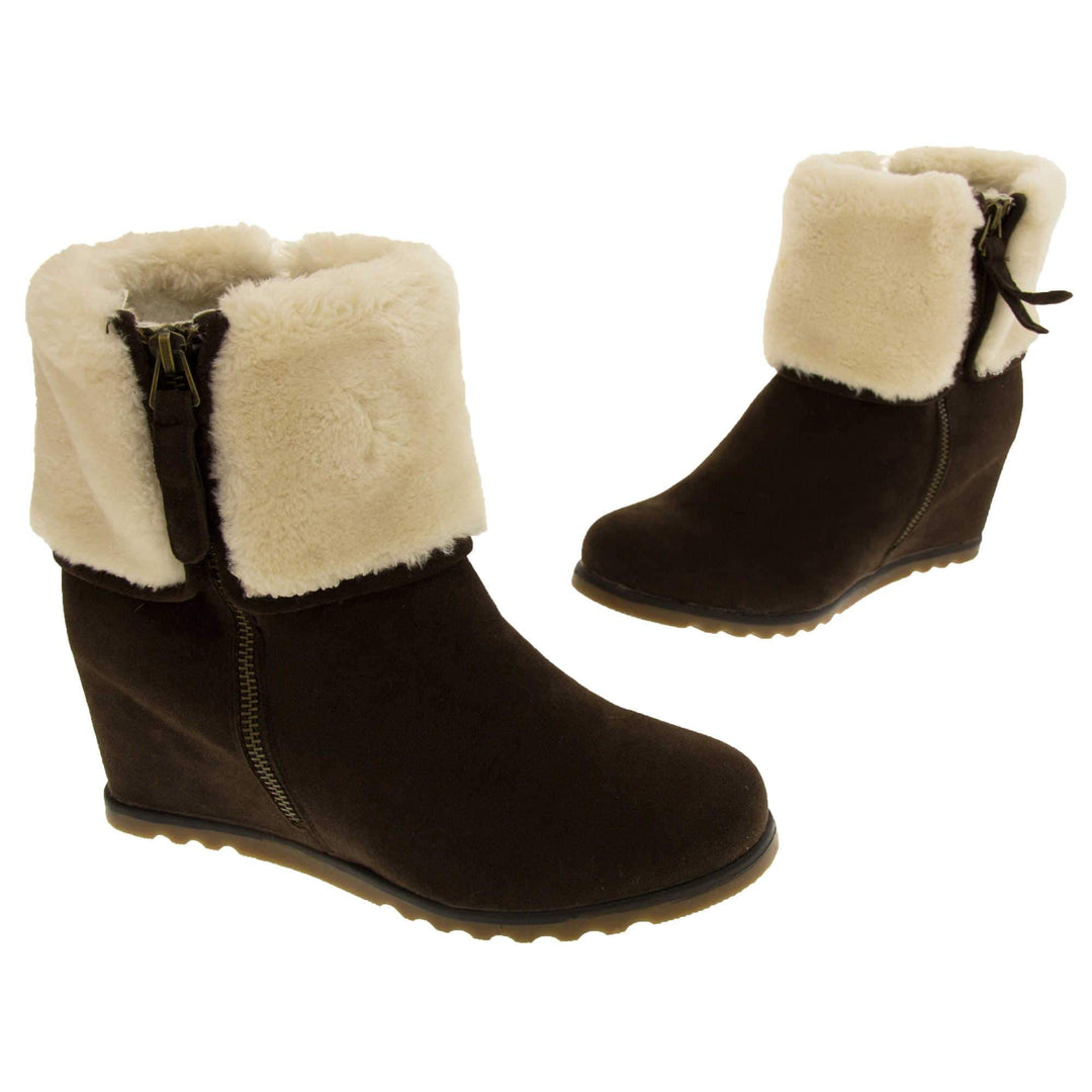 Ladies ankle boots. Dark brown faux suede wedge ankle boots. With zip fastening. Cream faux fur wide collar. Light brown sole with deep grip to the base. Both feet in a T shape about an inch apart.