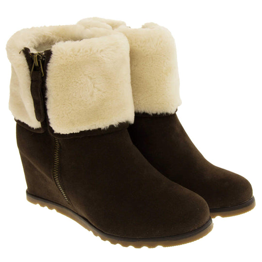 Ladies ankle boots. Dark brown faux suede wedge ankle boots. With zip fastening. Cream faux fur wide collar. Light brown sole with deep grip to the base. Both feet together at an angle.