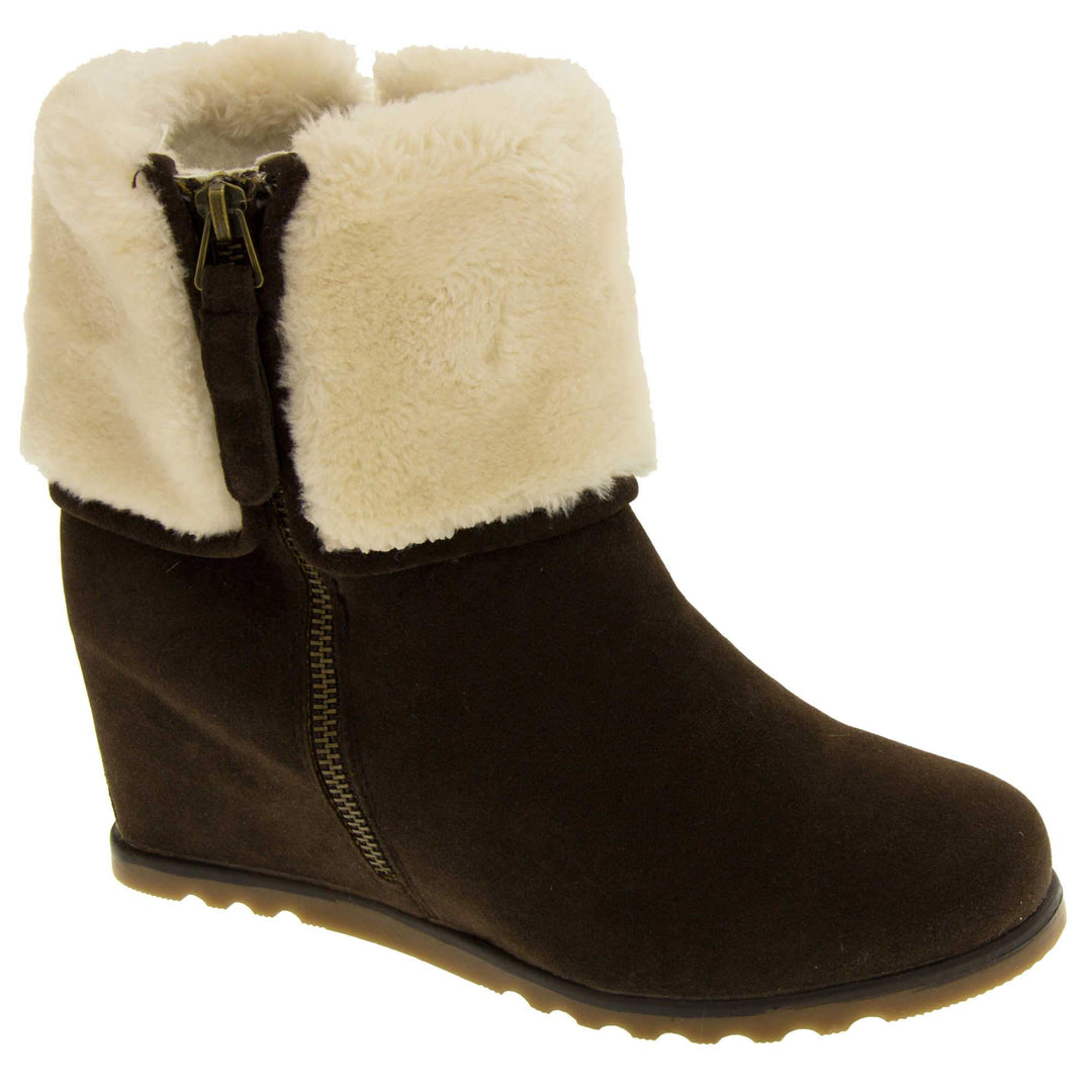 Ladies ankle boots. Dark brown faux suede wedge ankle boots. With zip fastening. Cream faux fur wide collar. Light brown sole with deep grip to the base. Right foot at an angle.