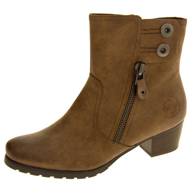 Ladies brown ankle boots.  With a brown faux suede upper. Zip fastening to the inside leg. decorative zip and two button fastening to the outside of the shoe. Dark brown sole with small block heel. Left foot at an angle.