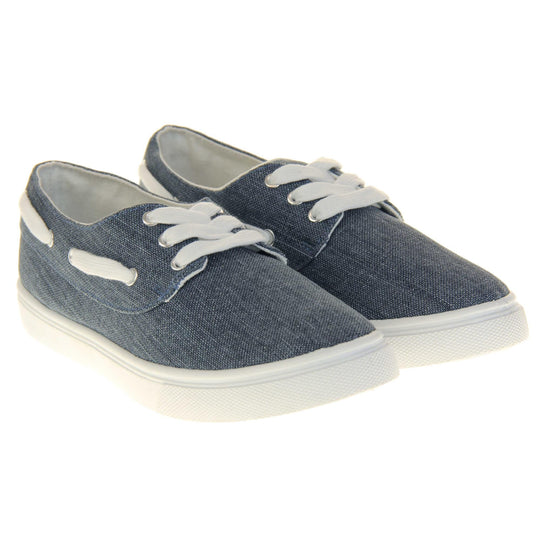 Ladies canvas slip on shoes. Sneaker style shoes with a navy blue canvas upper and white laces and white lace detailing around the outside of the collar. White outsole with slip-resistant grip to the bottom. Both feet together at a slight angle.
