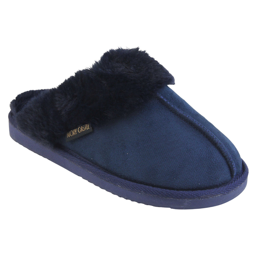 Ladies Faux Fur Mule Slippers. Slip on style slippers with Navy blue faux suede uppers. Navy faux fur lining and collar. Firm blue outsole with grip on the bottom. Right foot at an angle.