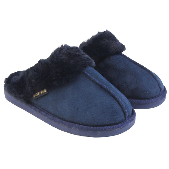 Ladies Faux Fur Mule Slippers. Slip on style slippers with Navy blue faux suede uppers. Navy faux fur lining and collar. Firm blue outsole with grip on the bottom. Both feet together at an angle.