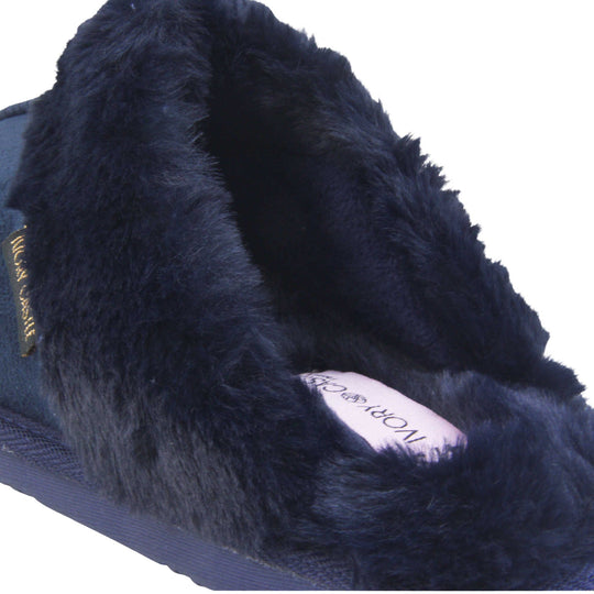Ladies Faux Fur Mule Slippers. Slip on style slippers with Navy blue faux suede uppers. Navy faux fur lining and collar. Firm blue outsole with grip on the bottom. Close up of the fluffy lining and collar.
