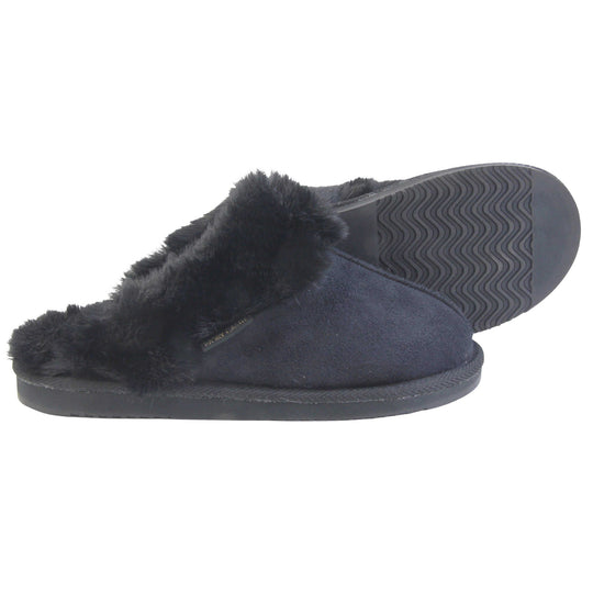 Ladies Memory Foam Slippers. Mule style slippers with black faux suede uppers. Black faux fur lining and collar. Firm black outsole with grip on the bottom. Both feet from a side profile with the left foot on its side behind the the right foot to show the sole.